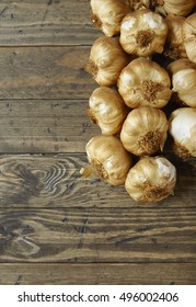 Aerial View Of Garlic Bulbs Arranged On A Rustic Wooden Kitchen Counter Background