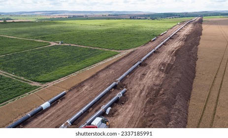 Aerial view of gas and oil pipeline construction. Pipes welded together. Big pipeline is under construction.