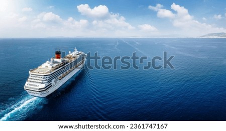 Aerial view of a generic cruise ship traveling with speed over blue ocean with copy space