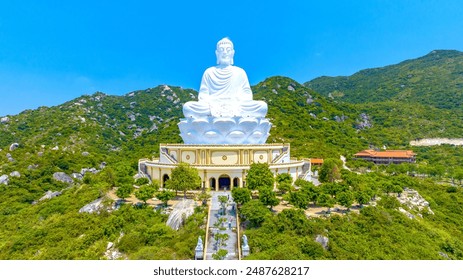 Aerial view of giant Buddha Statue on top of the mountain overlooking the sea Central Vietnam as pray good weather, smooth sea for fishermen fishing easier