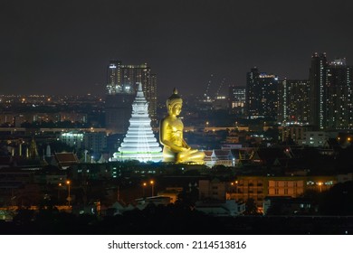 Aerial view of the Giant Golden Buddha in Wat Paknam Phasi Charoen Temple in Phasi Charoen district on Chao Phraya River at night, Bangkok. Urban town, Thailand. Downtown City.