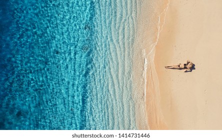 Aerial View Of A Girl On The Beach. Vacation And Adventure. Beach And Turquoise Water. Top View From Drone At Beach, Azure Sea And Relax Girl. Travel And Relax - Image