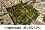 Aerial view of the Giuseppe Garibaldi public gardens in Lecce, Puglia, Italy. It is a green area with trees and flowerbeds in the historic center of the apulian city, near Basilica of Santa Croce.