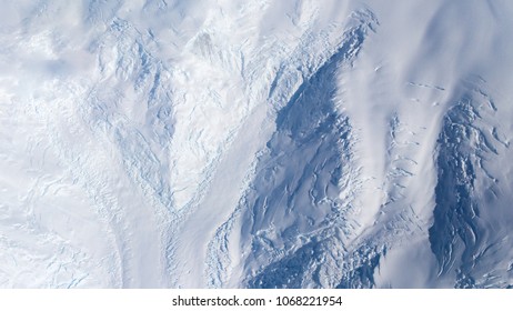 Aerial view of glaciers, mountains and crevasses, Antarctica - Powered by Shutterstock