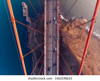 Aerial View Of Golden Gate Bridge In Foggy Visibility During Evening Time, Metropolitan Transportation  Infrastructure, Birds Eye View Of Automotive Car Vehicles On Road Of Suspension Construction 