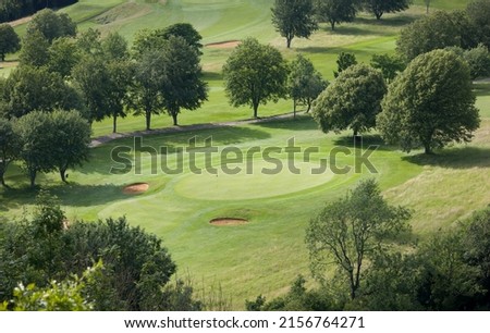 Aerial view of golf course in country landscape, UK golf scene viewed from above