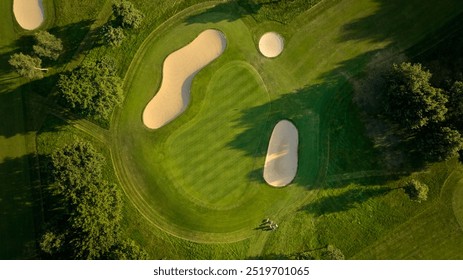 Aerial View of Golf Course Green and Bunkers, howcasing a well-maintained green surrounded by sandy bunkers.