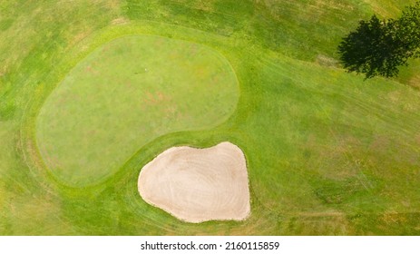 Aerial View Of A Golf Course In The Morning. There Are No People On The Putting Green.