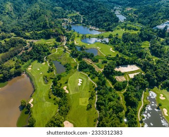 Aerial view of Golf Course with putting green grass and trees on golf field Fairway and putting green top view Amazing bird eye view over Golf courses in summer sunny day
