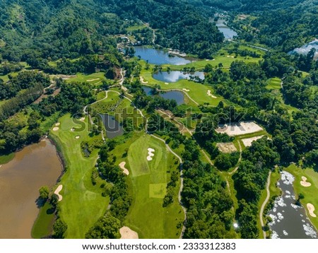 Aerial view of Golf Course with putting green grass and trees on golf field Fairway and putting green top view Amazing bird eye view over Golf courses in summer sunny day