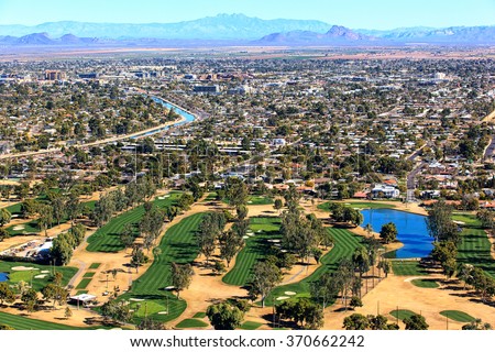 Aerial view of golf course with Scottsdale, Arizona skyline
