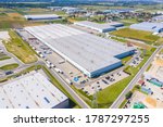 Aerial view of goods warehouse. Logistics center in industrial city zone from above. Aerial view of trucks loading at logistic center stock photo