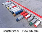 Aerial view of goods warehouse. Logistics center in industrial city zone from above. Aerial view of trucks loading at logistic center. View from drone.