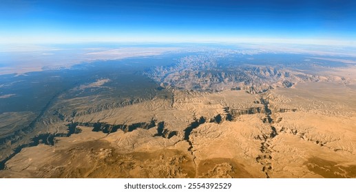 An aerial view of the Grand Canyon, showcasing its immense depth and the vast expanse of the surrounding desert landscape. - Powered by Shutterstock