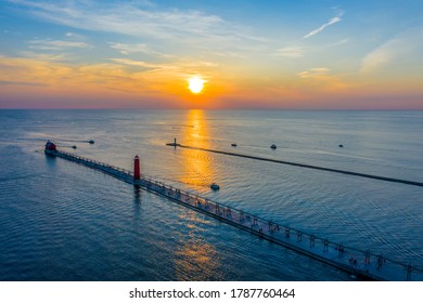 Aerial view of the Grand Haven South Pier and North Pier Lighthouses at sunset along Lake Michigan; Grand Haven, Michigan