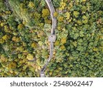 Aerial view of the Great Wall of China with autumn color leaves, a few people walking and a watchtower in Huairuou, near Beijing, China