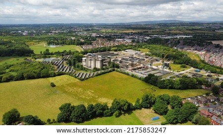 Aerial view of green countryside and buildings with a sky background. Taken in Bury Lancashire England. 