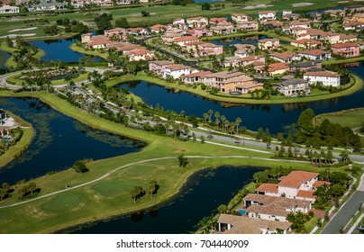 Aerial View Of Green Florida Residential Community And Golf Course