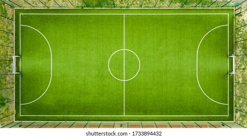 Aerial View Of A Green Football Field At Day Time.