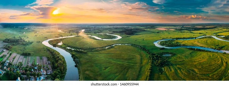 Aerial View Green Forest Woods Meadow And River Landscape In Sunny Spring Evening. Top View Of Beautiful European Nature From High Attitude In Summer Sunset Sunrise. Panorama, Drone View. Belarus.