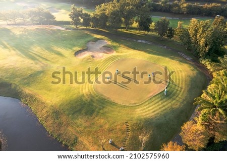 Similar – A tranquil aerial view of a lush golf course fairway, bathed in the warm glow of sunset. Ideal for themes of relaxation, nature, and sports, this image captures the peaceful beauty of the golfing experience.