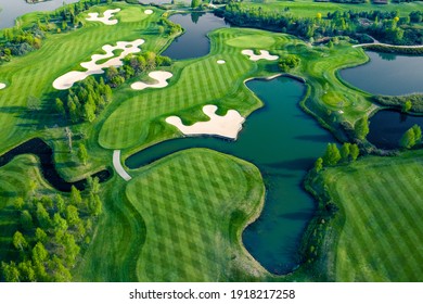 Aerial view of green grass and trees on a golf field.