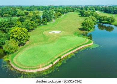 Aerial view of green lawn and forest on golf course.Green golf course scenery.