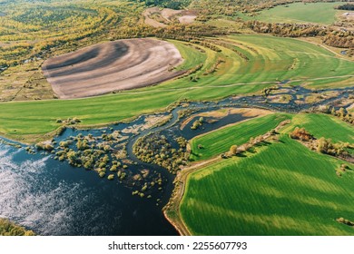 Aerial View Green meadows And River Landscape In Sunny Spring Summer Day. Top View Of Nature, Bird's Eye View. Trees Standing In Water During Spring Flood floodwaters. woods in Water deluge During A - Shutterstock ID 2255607793
