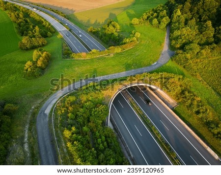 Aerial view of a green overpass over almost empty highway.