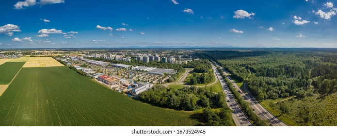 Aerial View Of A Green Rural Area Under Blue Sky With Fields.