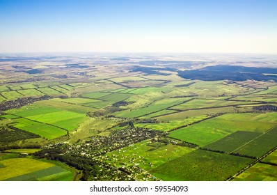 Aerial view of a green rural area under blue sky