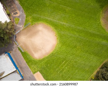 Aerial View. Green Sports Field For Playing Football, Rugby, Baseball, Golf. Sports Games, Amateur And Professional Sports, Recreation, Healthy Lifestyle. There Are No People In The Photo.