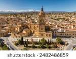 Aerial view of Guadix old town, province of Granada, Andalusia, Spain. Historic Cathedral building, Alcazaba de Guadix fortress and snow capped Sierra Nevada mountain range at background