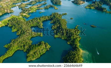 Aerial view of the Guatape reservoir or lake, with an island surrounded by water in Guatape, Antioquia, Colombia near the city of Medellin