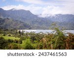 Aerial view of Hanelei Bay and beach with Napali Coast in the background, palms Hanalei town on a sunny day, North Shore of Kauai, Hawaii