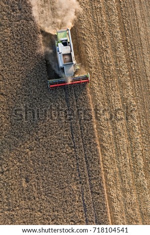 Similar – Combine harvester harvests a grain field in the evening light from the air