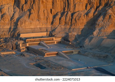 Aerial view of Hatshepsut Temple at sunrise in Valley of the Kings and red cliffs western bank of Nile river- Luxor- Egypt - Shutterstock ID 2224071013