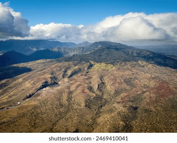 Aerial view of Hawaiian island of Oahu  with Nanakuli Forest Reserve in the background against blue sky with clouds - Powered by Shutterstock