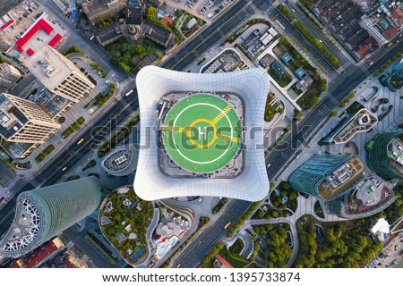 Aerial view of helipad. Helicopter landing pad on rooftop on skyscraper, high-rise office building in Shanghai Downtown, China. Financial district and business centers in smart city in Asia.