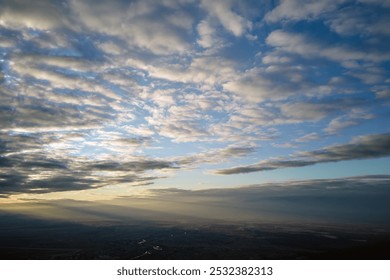 Aerial view at high altitude of dense puffy cumulus clouds forming before rainstorm in evening