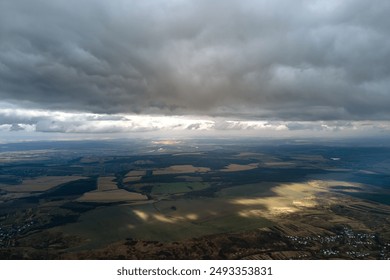 Aerial view from high altitude of earth covered with puffy rainy clouds forming before rainstorm - Powered by Shutterstock