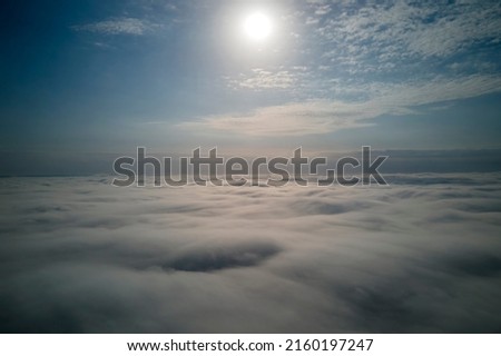 Aerial view from high altitude of earth covered with puffy rainy clouds forming before rainstorm