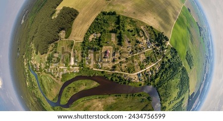 Aerial view from high altitude tiny planet in sky with clouds overlooking old town, urban development, buildings and crossroads. Transformation of spherical 360 panorama in abstract aerial view.