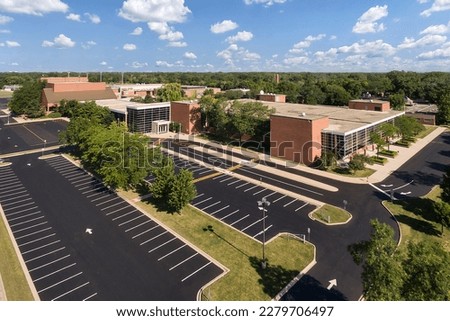 Aerial view of a high school with parking lot in a suburban setting in Northbrook, IL