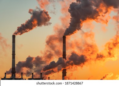 Aerial View Of High Smoke Stack With Smoke Emission. Plant Pipes Pollute Atmosphere. Industrial Factory Pollution, Smokestack Exhaust Gases. Industry Zone, Thick Smoke Plumes. Climate Change, Ecology