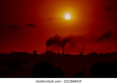 Aerial View Of High Smoke Stack With Smoke Emission. Plant Pipes Pollute Atmosphere. Silhouette Background.