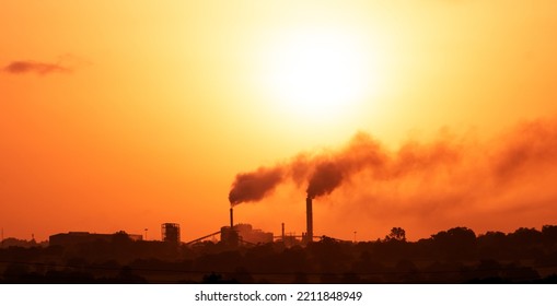 Aerial View Of High Smoke Stack With Smoke Emission. Plant Pipes Pollute Atmosphere. Silhouette Background.