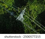 Aerial view of high voltage electric tower in forest