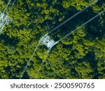 Aerial view of high voltage electric tower in forest