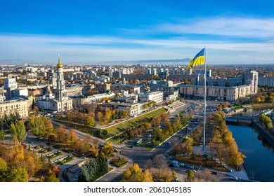 Aerial view to highest ukrainian flag waving in flagpole at Serhiyivsyi Square on embankment of Lopan river in Kharkiv, Ukraine